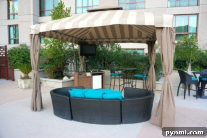 Pechanga Resort and Casino: A Deep Dive into the Experience 10 The expansive, resort-style pool area at Pechanga Resort Casino, with palm trees and modern loungers, bathed in the warm glow of the evening.