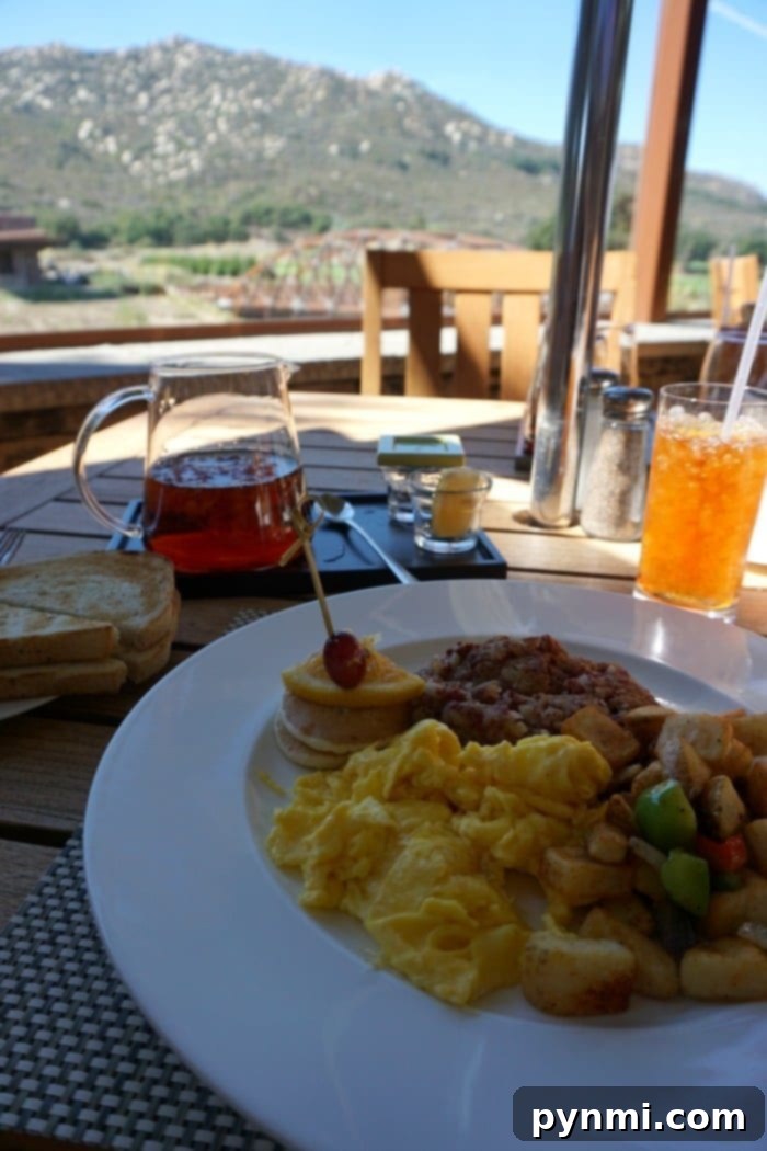 Pechanga Resort and Casino: A Deep Dive into the Experience 6 A scenic view from the outdoor patio of Journey's End restaurant at Pechanga, overlooking the vibrant green golf course and distant mountains under a clear sky.