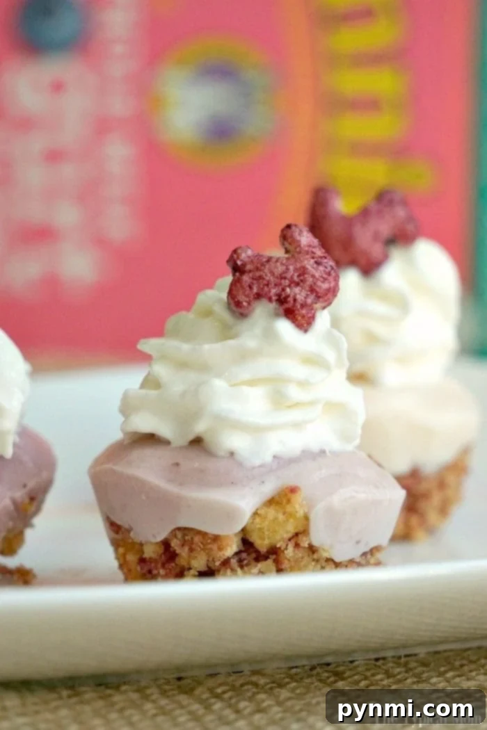 Frozen yogurt cupcakes topped with whipped cream and cereal bunnies, arranged on a vibrant plate.
