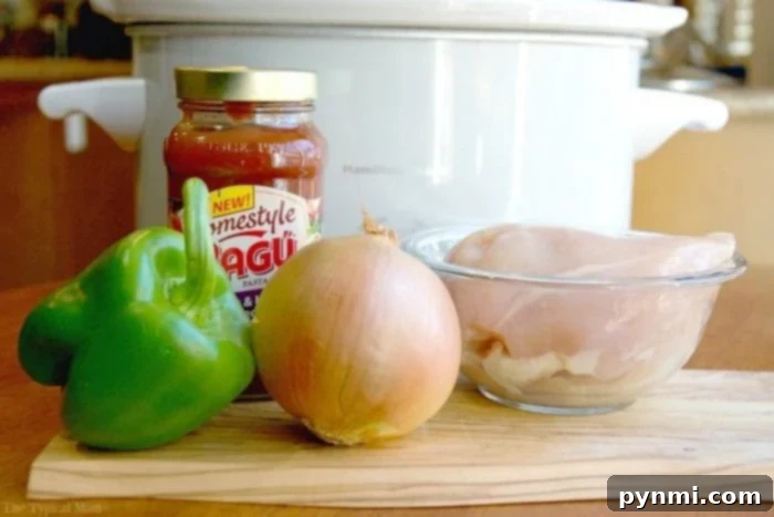 Hearty Slow Cooker Hunter's Chicken 3 slow-cooker-chicken-cacciatore, a close-up of tender chicken pieces simmering in a rich tomato sauce with sliced bell peppers and onions in a slow cooker.