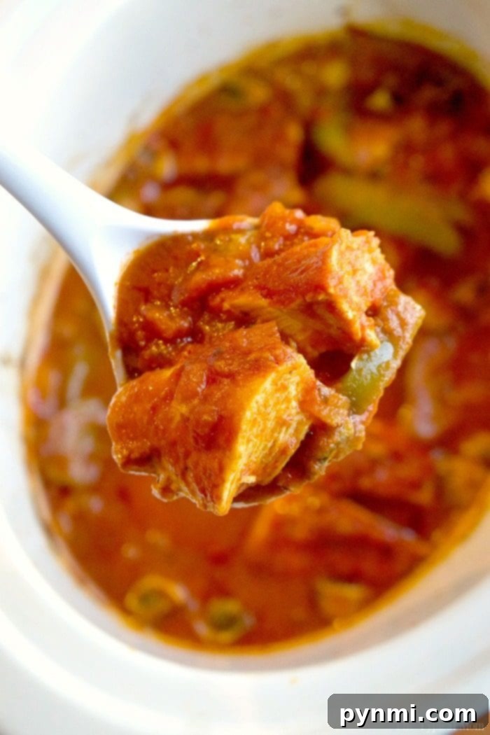 Hearty Slow Cooker Hunter's Chicken 5 crockpot chicken cacciatore with jar sauce, a hearty slow cooker meal, ready to serve over rice, showcasing tender chicken and vibrant vegetables.