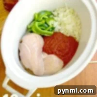 Crockpot chicken cacciatore with raw chicken, sliced green peppers, chopped onions, and sauce; 10 min. prep for a flavorful slow-cooked delight.