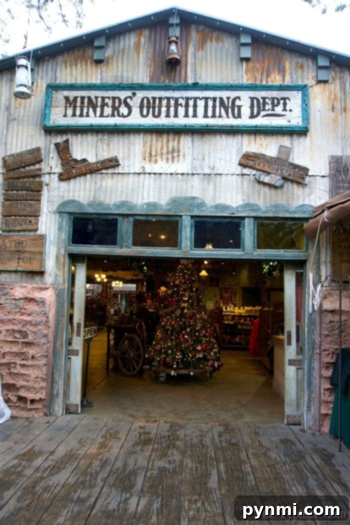 Santa Claus interacting with children in his festive Christmas Cabin at Knott's Merry Farm, surrounded by holiday decorations and treats.