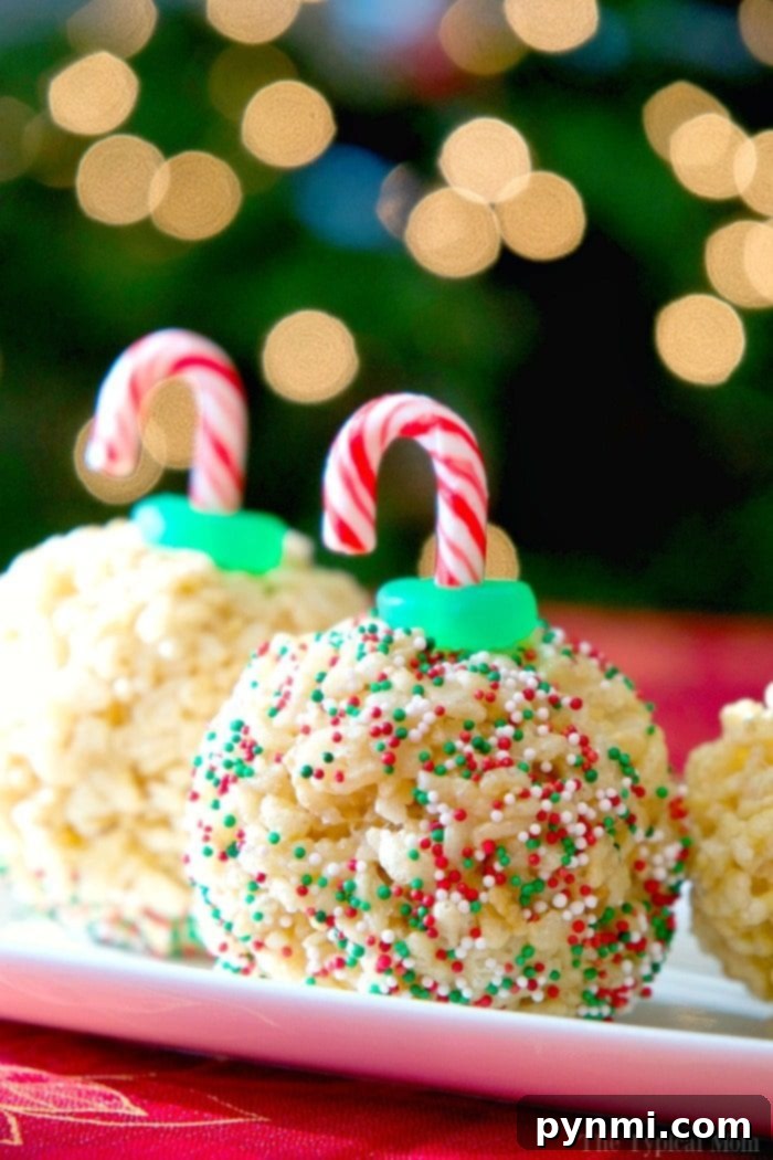 An array of finished Rice Krispy Treat Ornaments, adorned with candy canes and sprinkles, on a white tray.