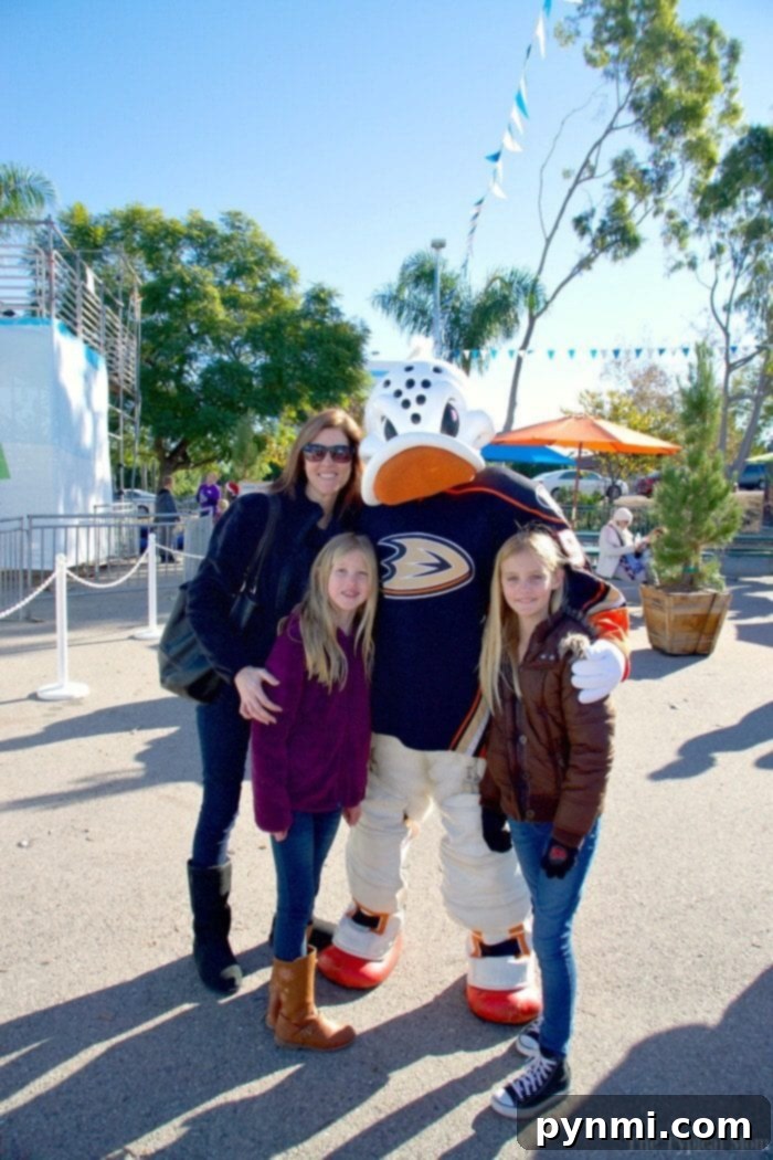 Families playing in the artificial snow at Discovery Cube OC's outdoor winter event.