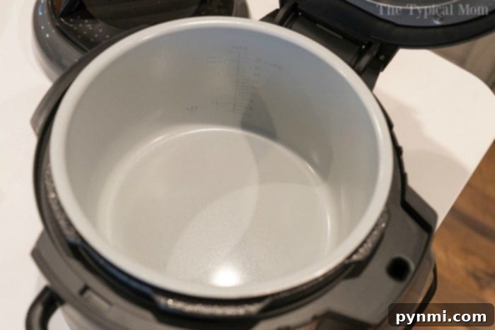 Open modern pressure cooker with a non-stick interior sits on the kitchen counter, ready for your next culinary adventure. Keep it pristine and performing at its best by learning how to clean your instant pot efficiently.