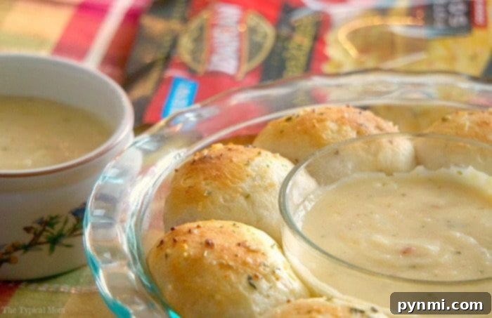 Savory Bacon Cheese Pull-Apart Bread 4 Freshly baked cheesy biscuits arranged around a ramekin, showcasing their golden-brown tops.