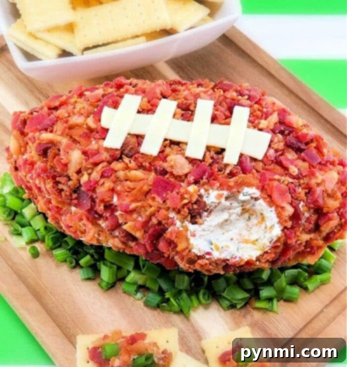 Touchdown Cream Cheese Ball 2 Football Shaped Cheese Ball with Cream Cheese, garnished with bacon and provolone stitching, served on a platter