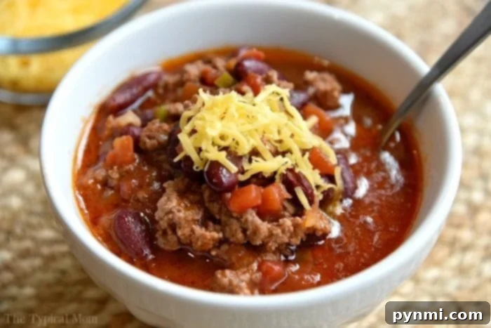 Easiest Instant Pot chili recipe ever and costs less than $10 total to make. Healthy pressure cooker dinner that even my kids go crazy over! We make this at least once a week and serve it as is topped with cheese or on top a bowl of rice. A vibrant bowl of Instant Pot chili mac, featuring a rich, meaty chili base combined with tender elbow macaroni, topped with melted cheese and fresh parsley, perfect for a hearty family meal.