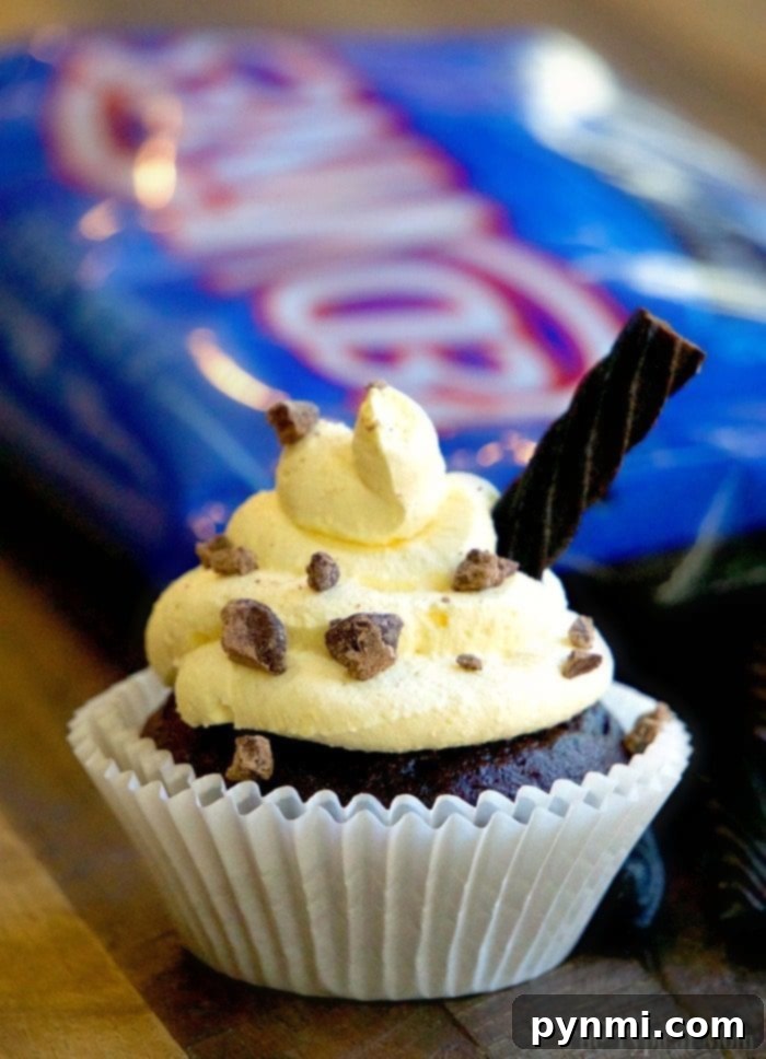 Delicious Baileys and Cream Cupcakes, filled with creamy Baileys pudding and topped with smooth vanilla frosting and a licorice straw.