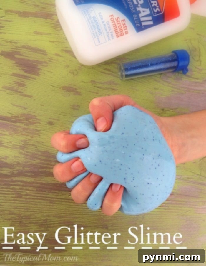 Vibrant glitter slime made with glue, showcasing its stretchiness and sparkle.