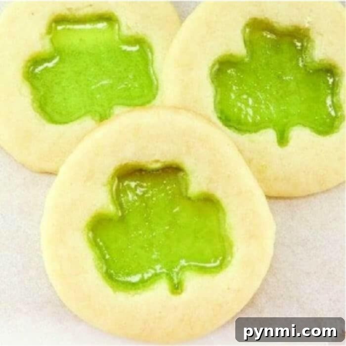 Crafting Edible Gems: Stained Glass Cookies 2 How to make stained glass cookies with melted Jolly Ranchers, showcasing a finished shamrock cookie on a cooling rack.