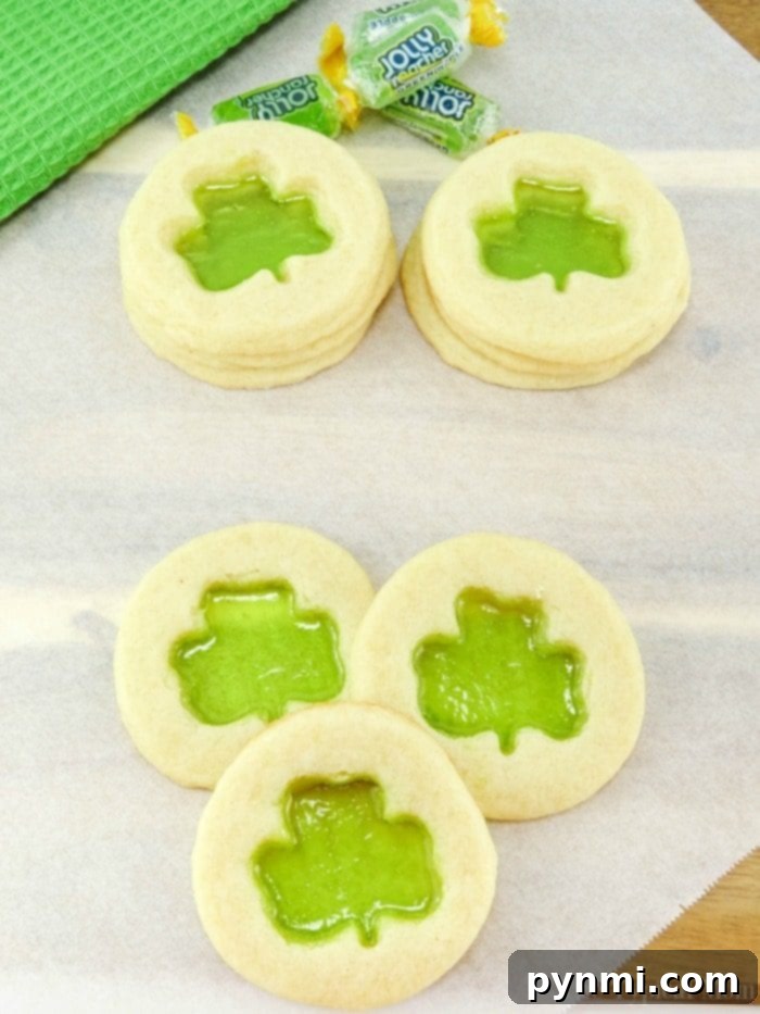 The cutest Shamrock cookies that are easy to make. Great St.Patrick's Day dessert to make with your kids that taste great and look really cute. Adorable shamrock cookies with green stained glass centers, perfect for St. Patrick's Day celebrations.