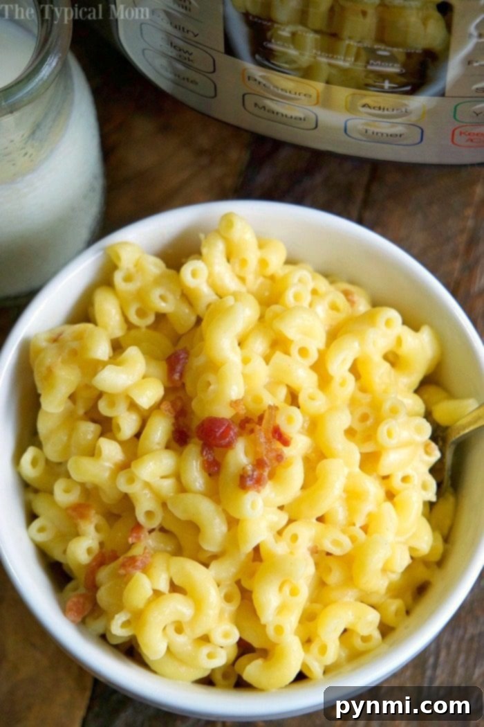 One-Pot Wonder Mac 4 Close-up of golden, bubbling Instant Pot macaroni and cheese in a bowl, steam rising, ready to be enjoyed.