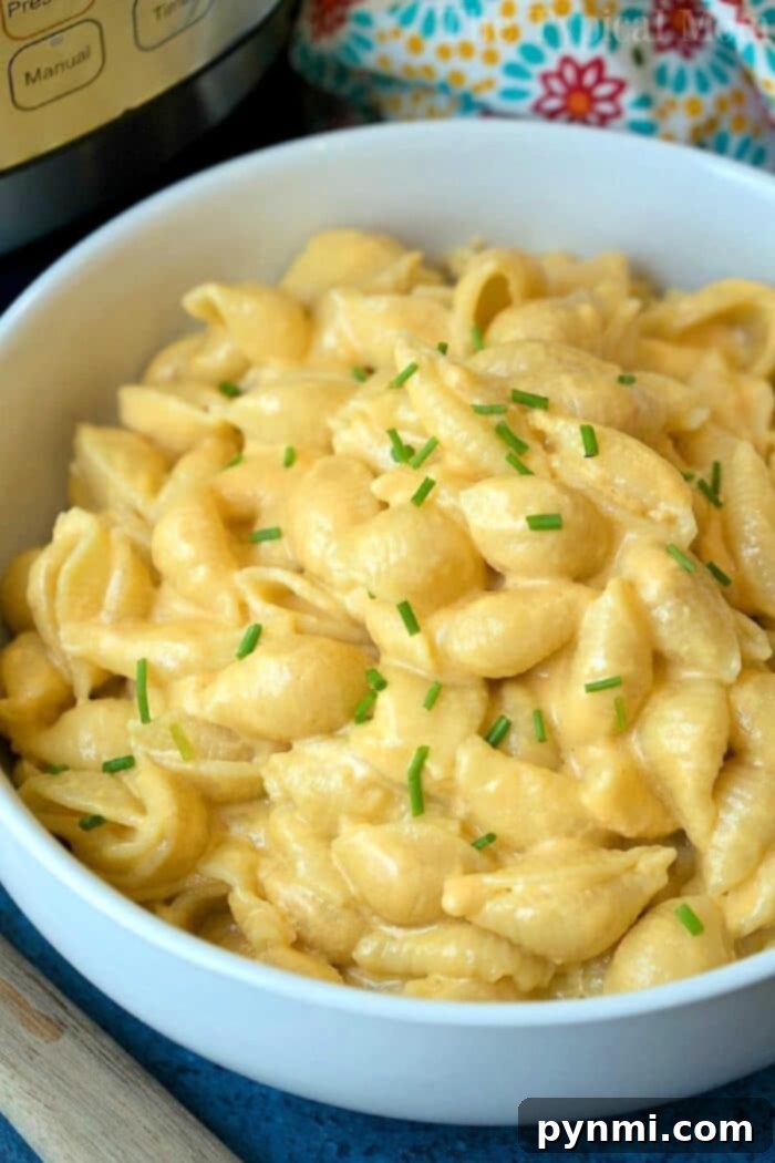 One-Pot Wonder Mac 7 A generously portioned bowl of golden, rich Instant Pot Mac and Cheese, showcasing its creamy texture.