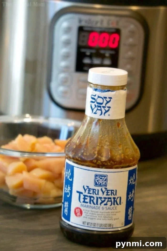 Enjoy tender, flavorful Instant Pot Teriyaki Chicken in just 3 minutes! This healthy, inexpensive pressure cooker recipe is perfect with rice and pineapple, making it a kid-friendly weeknight delight. Close-up of pressure cooker teriyaki chicken with sauce.