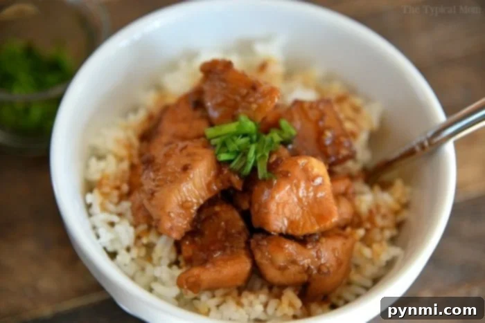 This effortless 3-ingredient Instant Pot Teriyaki Chicken cooks in just 3 minutes, resulting in incredibly tender and flavorful meat. A healthy and budget-friendly pressure cooker recipe, it's a family favorite over rice, especially with a hint of pineapple. Instant Pot teriyaki chicken in a serving bowl with chopsticks.
