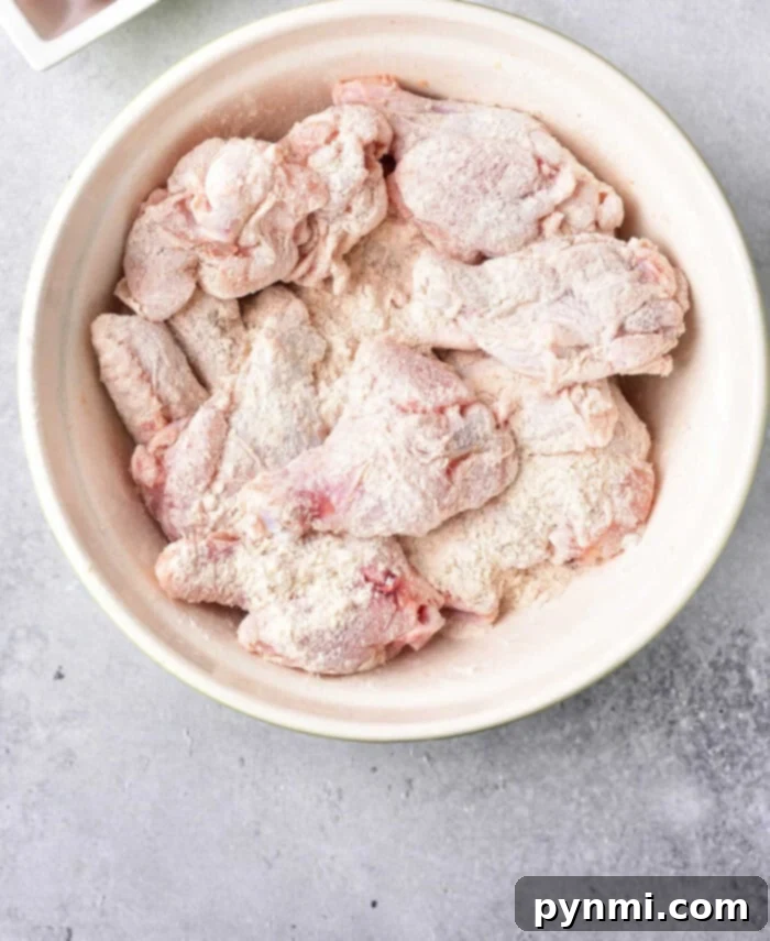 Achieve Crispy Baked Wings: The 425 Method 4 Raw chicken wings evenly coated in baking powder and salt, ready for baking to achieve ultimate crispiness