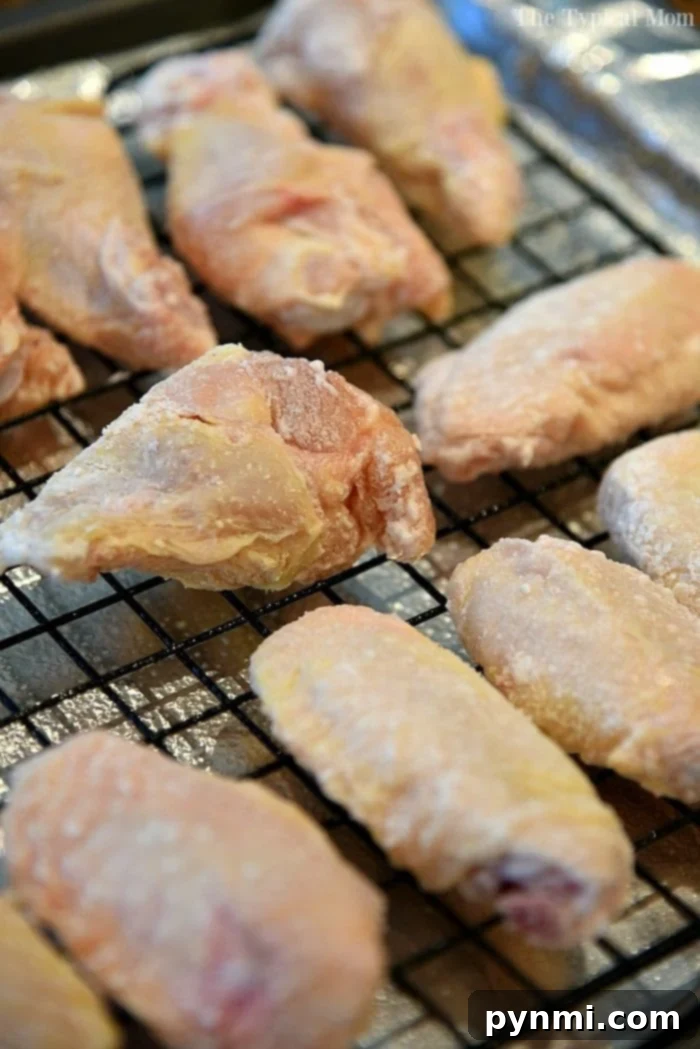 Achieve Crispy Baked Wings: The 425 Method 5 A vibrant platter of Sriracha-glazed crispy chicken wings, ready to be served as an appetizer