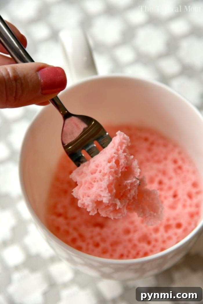Strawberry cake in a mug recipe that uses just 3 ingredients and takes just 1 minute in the microwave! So moist, it's the perfect dessert for one! #mugcake #cake #microwave #dessert #strawberry #angelfoodcake strawberry cake in a mug