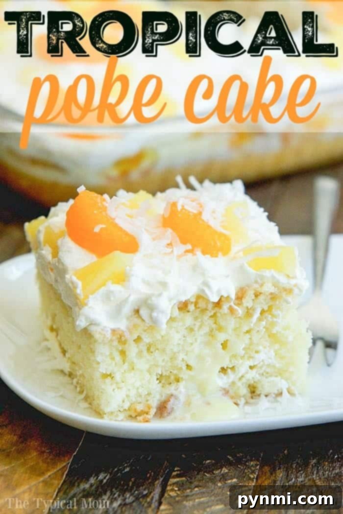 Delicious Tropical Poke Cake garnished with fresh orange slices, pineapple, and shredded coconut, perfect for a summer dessert.