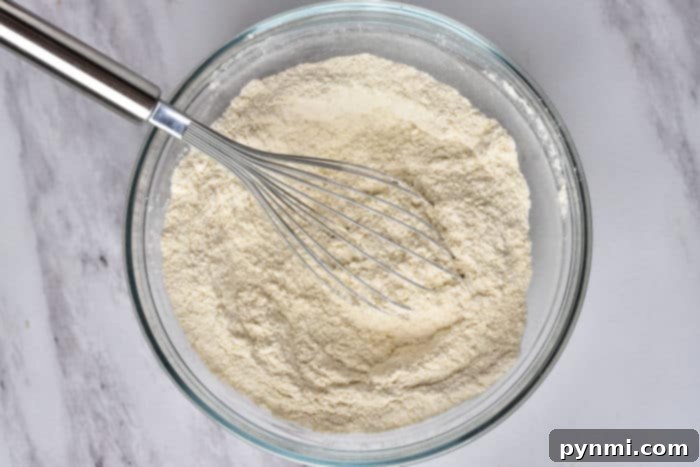 Ingredients for a cake mix recipe, showcasing a box of white cake mix along with eggs, oil, and water, ready for baking.