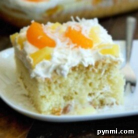Hawaiian poke cake with tropical fruits and coconut topping