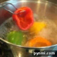A pot of water bubbles away as tender bell peppers simmer, while a vibrant red pepper is carefully lifted out with tongs. This scene sets the stage for a delicious stuffed green peppers recipe waiting to delight your taste buds.