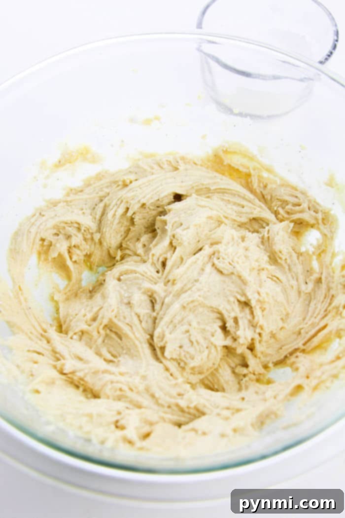 Orange cookie dough with white chocolate chips, ready for baking.