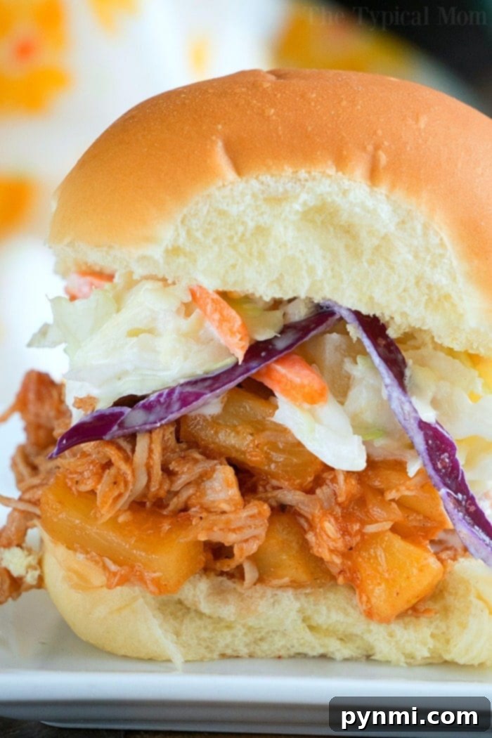 A delicious Instant Pot Hawaiian pulled pork sandwich with pineapple and coleslaw.