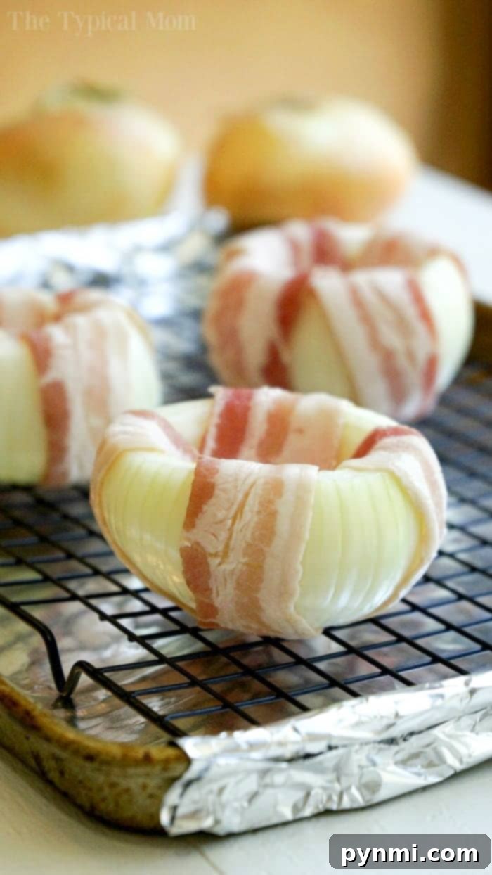 Delicious mozzarella stuffed bacon-wrapped onions, perfectly baked with cheese oozing out, ready to be enjoyed.