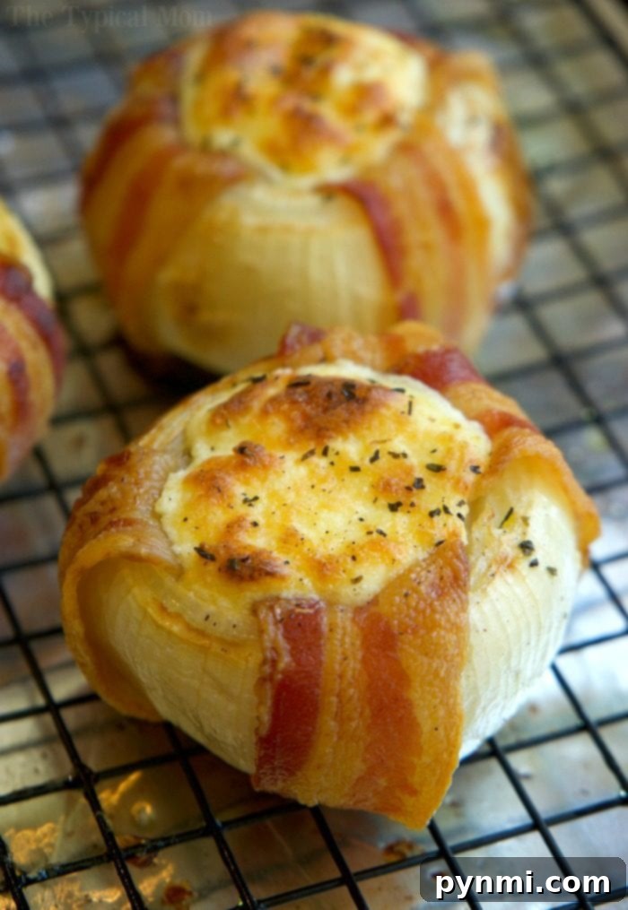 A freshly baked mozzarella stuffed bacon wrapped onion, with cheese bubbling and bacon crispy, ready to be served.