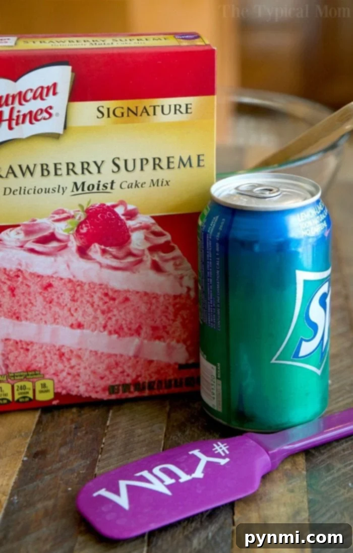Moist, Egg-Free 2-Ingredient Strawberry Cake: A Quick & Simple Dessert Solution! A slice of 2-ingredient strawberry cake topped with whipped cream and a fresh strawberry.
