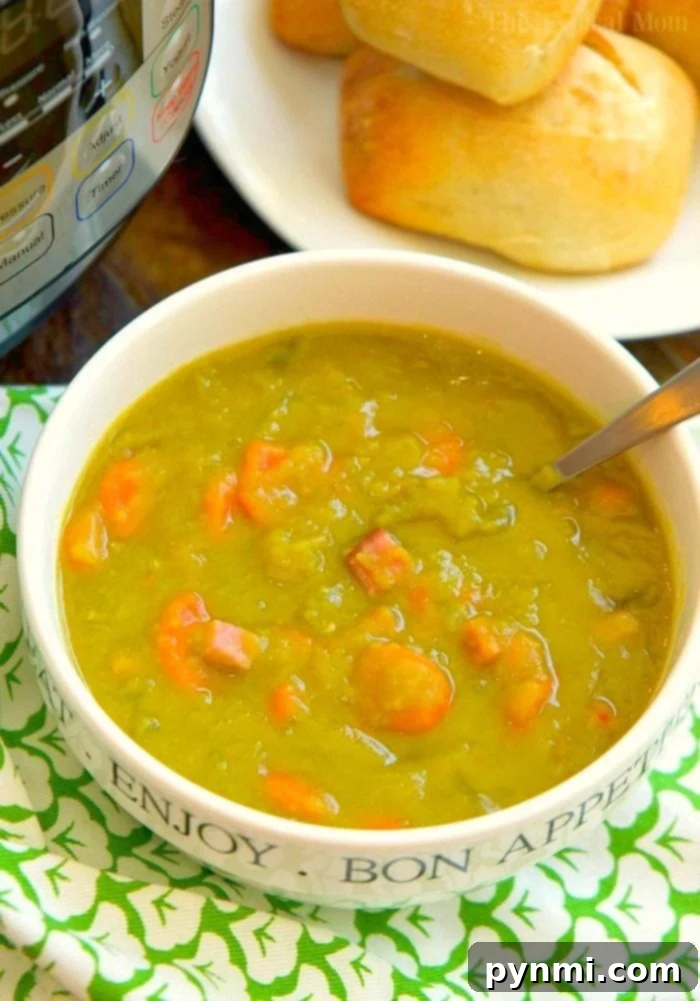 Creamy Instant Pot Split Pea Soup 2 Instant Pot split pea soup recipe with ham, carrots, onion, and celery. A close-up shot of the steaming soup in a bowl.
