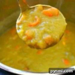 Ladle scooping steaming Instant Pot split pea soup with carrots from a pot.