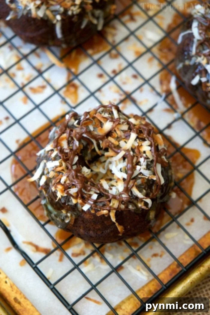 Samoa-inspired mini bundt cakes topped with caramel, toasted coconut, and a delicate chocolate drizzle.