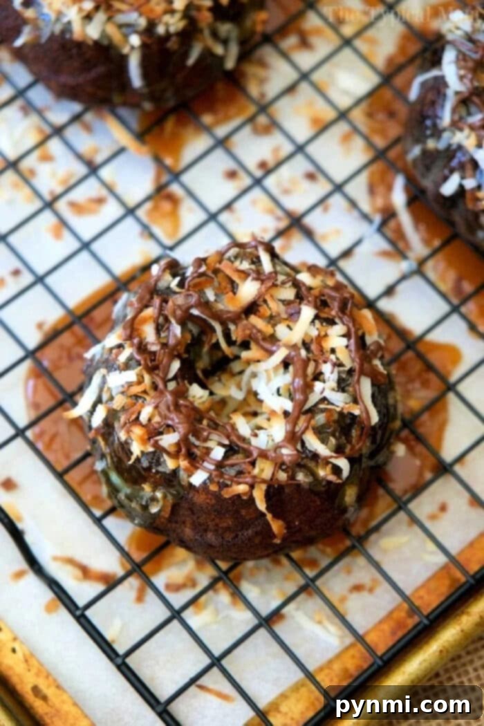 Two perfectly baked and decorated mini bundt cakes presented beautifully on a white plate, ready to be enjoyed.