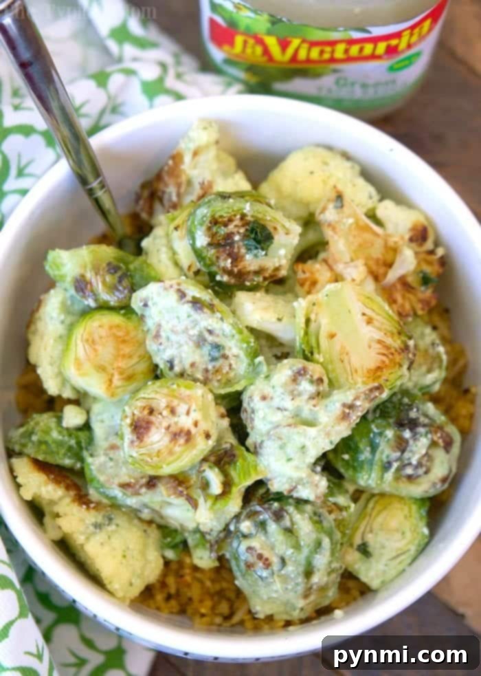 Creamy salsa verde brussel sprouts and cauliflower is a great side dish or vegetarian meal that is packed with punches of flavor! #brusselsprouts #califlower #baked #vegetable #vegetarian #crispy #keto #salsaverde Roasted Brussel Sprouts and Cauliflower with Creamy Salsa Verde