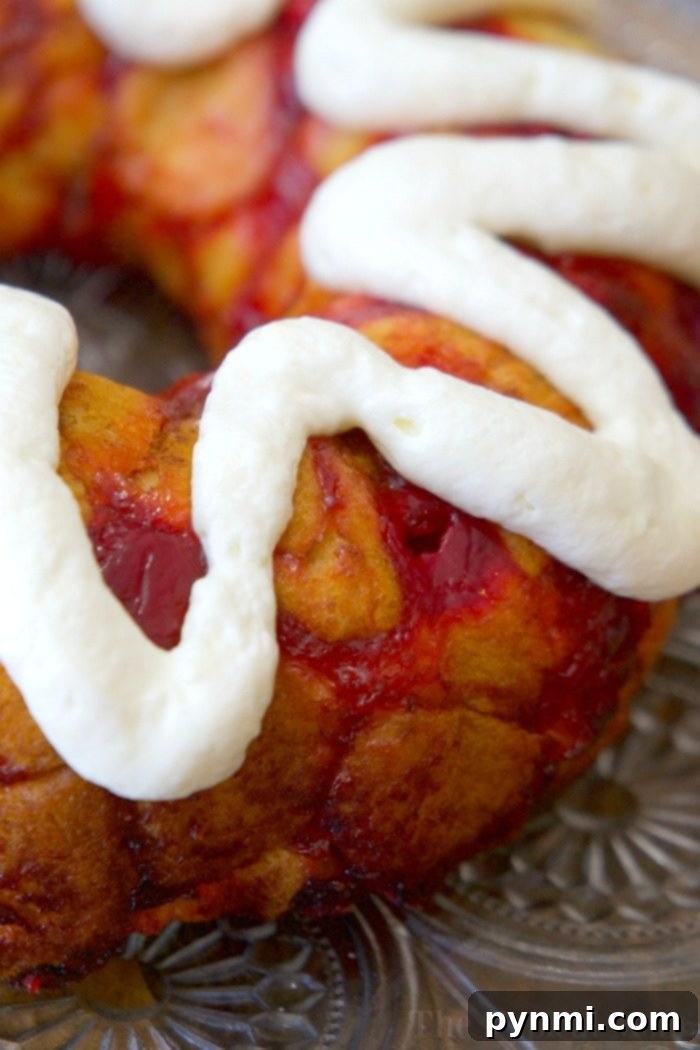 This cherry cheesecake monkey bread is so easy to make with refrigerated biscuits and tastes just amazing! It's a perfect treat for breakfast or dessert and it's a very simple bundt cake to make for any occasion. Using your favorite pie filling like cherry or blueberry you can make monkey bread at home too! #monkeybread #cherry #biscuit #easy #blueberry #fruit #quick #bundtcake #breakfast #dessert cherry cheesecake monkey bread
