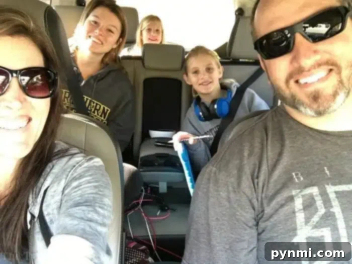 Family enjoying interactive car games for kids Smiling children wearing headphones and a couple enjoying road trip games in a car, making the journey fun.