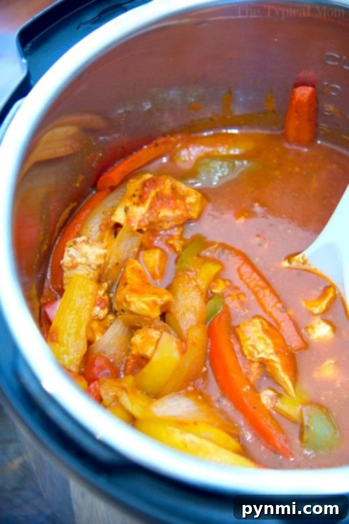 Instant Pot chicken cacciatore recipe: Quick, easy, and flavorful. Just 3 ingredients for a healthy low-carb dinner served over rice. Instant Pot Chicken Cacciatore with vegetables simmering in the pot, ready to be served.