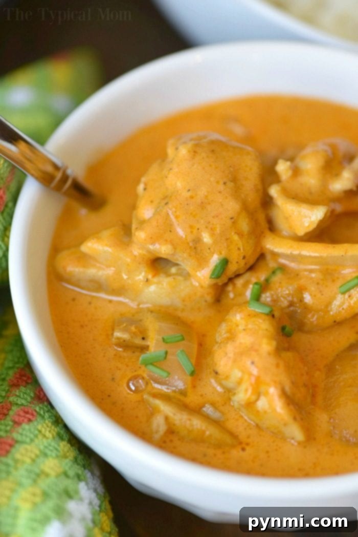 Creamy Instant Pot Butter Chicken Ready to Serve A serving of creamy Instant Pot butter chicken, adorned with fresh herbs, ready to be enjoyed with a side of rice or naan.