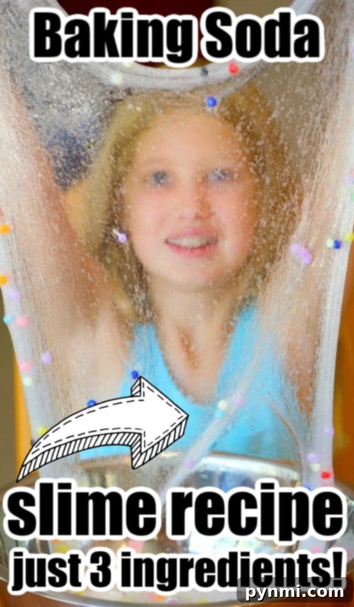 Clear baking soda slime being stretched by child's hands