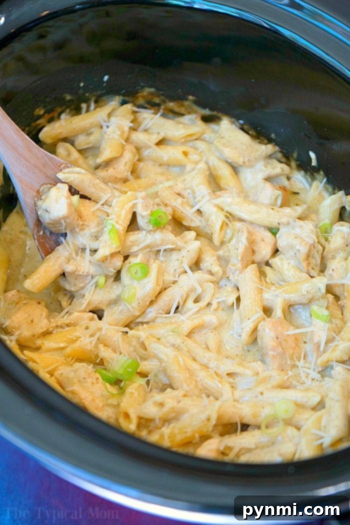 Family enjoying the crockpot pesto chicken alfredo casserole at a dinner table