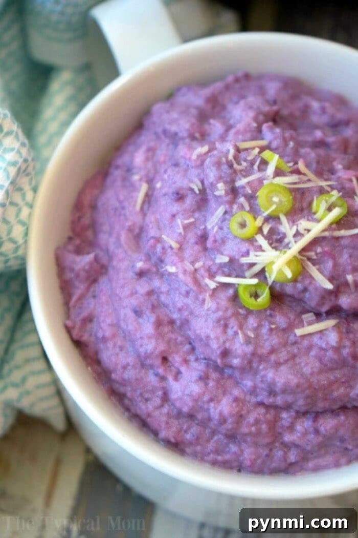 Instant Pot purple cauliflower mash in a bowl, garnished with fresh herbs.