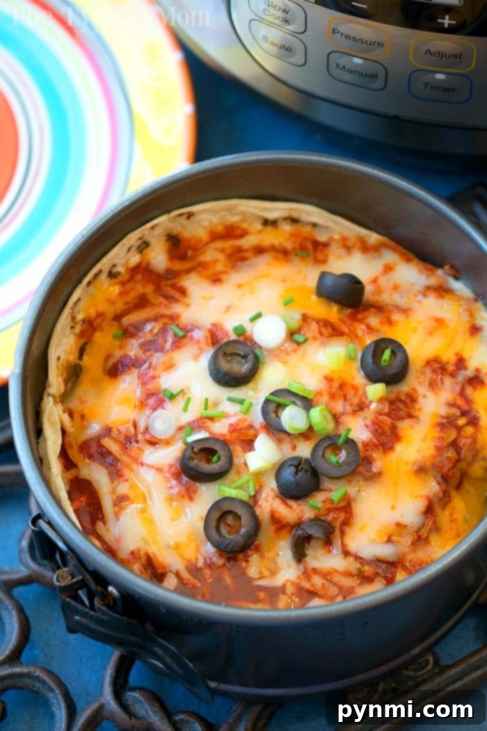 Instant Pot Mexican pizza is amazing!! With layers and layers of cheese, sauce and ground turkey it's like a wonderful enchilada lasagna! #instantpot #mexicanpizza #pizza #pressurecooker #instantpotrecipes #thetypicalmom instant pot mexican pizza 2