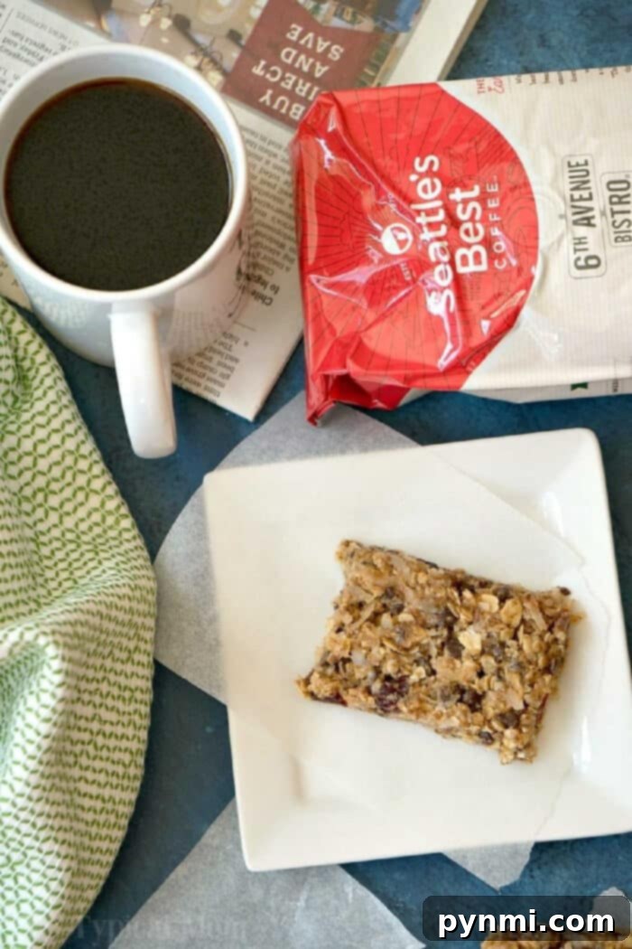 Close up of a single homemade granola bar with a bite taken out, highlighting its rich, chewy texture and ingredients