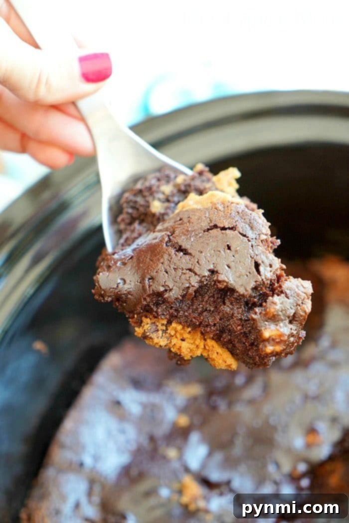 Gooey Crockpot Brownie Cookies with a layer of chocolate chip cookies and a layer of chocolate brownies, topped with a scoop of vanilla ice cream and colorful sprinkles. Easy slow cooker dessert for any occasion.