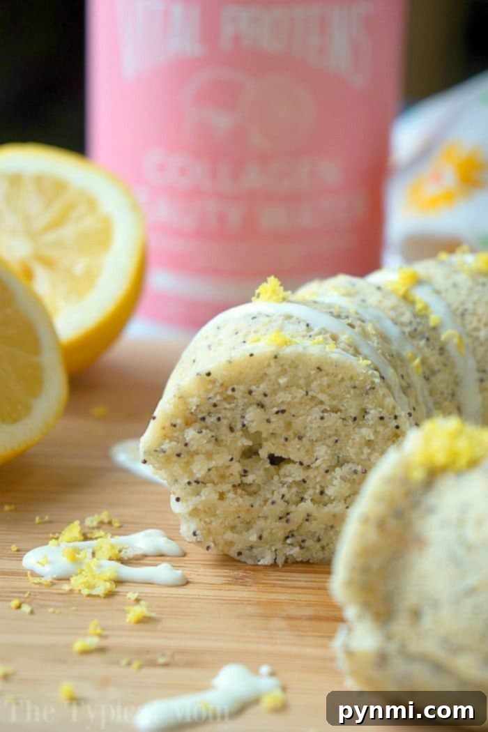 A generous slice of Instant Pot lemon poppy seed cake on a white plate, showcasing its moist texture and delicate crumb, with a gentle glaze.