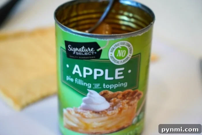 A vibrant close-up of chunky apple pie filling, ready to be used as a delicious stuffing for waffles or other desserts.